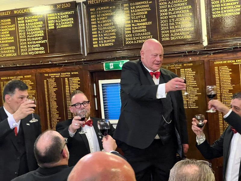Raising a glass beneath the honours boards